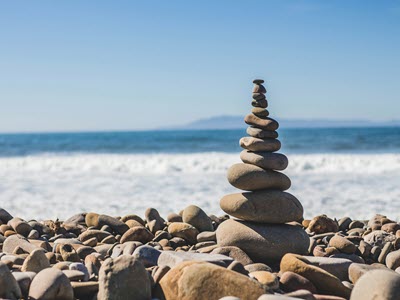 stack of rocks in front of the ocean