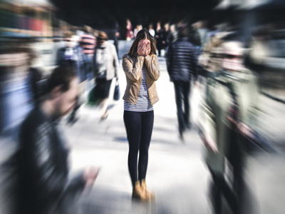 Person feeling anxiety in the middle of a crowd