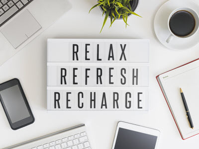 message board on desk that says: relax, refresh, recharge