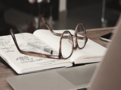 glasses on top of a notebook