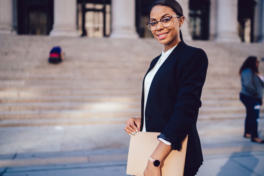 smiling law student holding portfolio