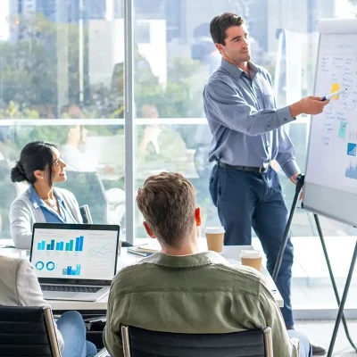Man standing at flip chart in front of colleagues