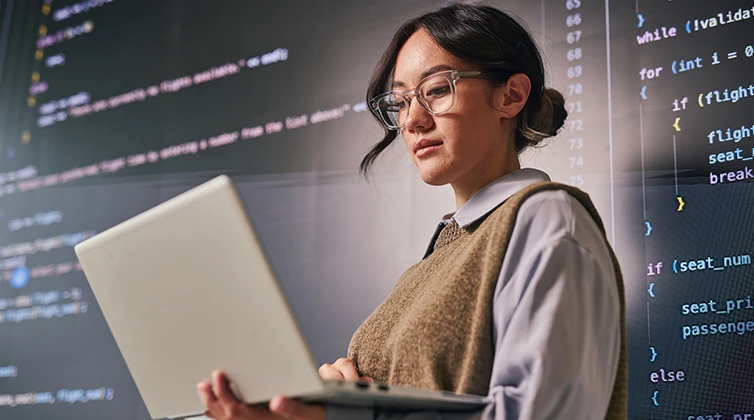 cybersecurity studies student working on laptop