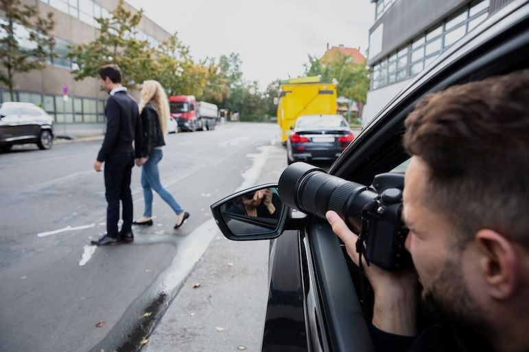 private investigator photographing couple