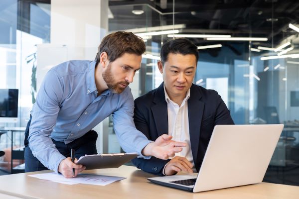 two business men looking at laptop