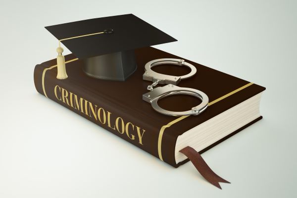 criminology textbook under graduation cap