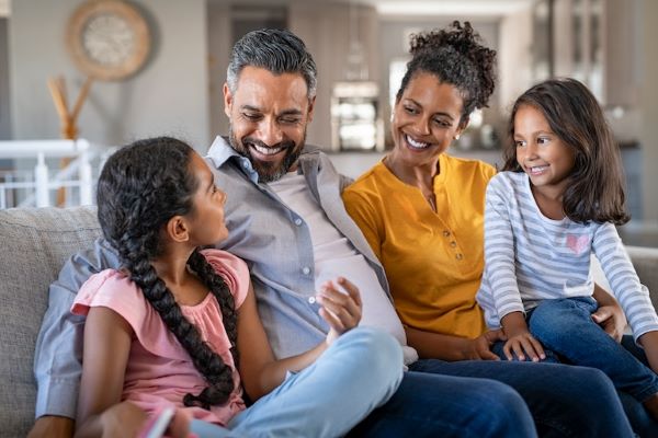 family sitting on couch