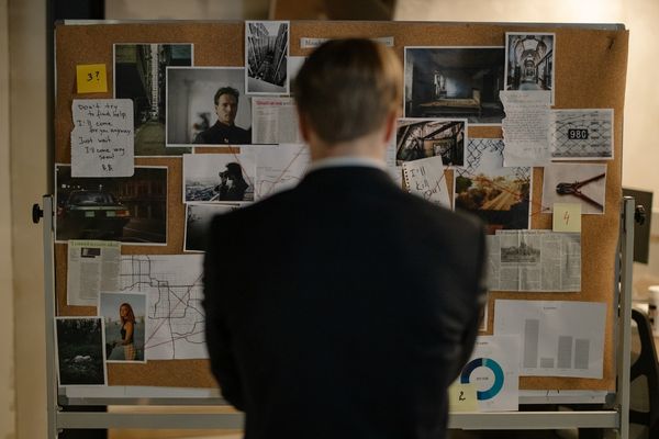 cybercrime investigator looking at evidence board