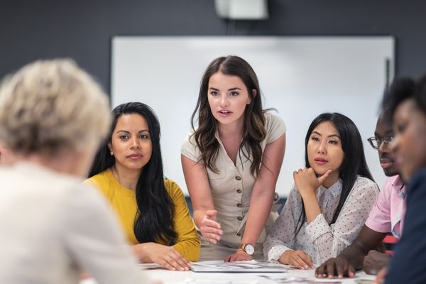 master's in intelligence graduate holding discussion in conference room