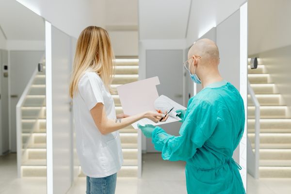 public health workers looking at medical chart