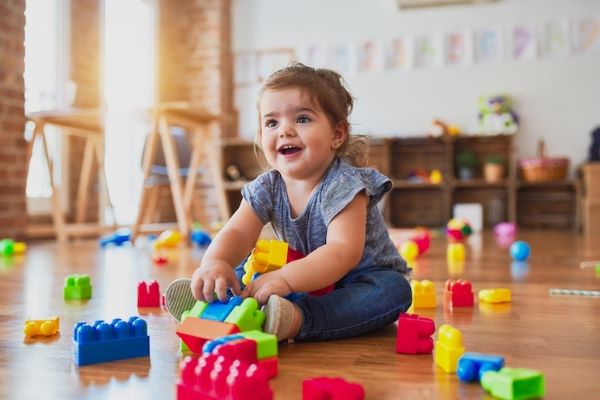 child in a daycare playing with blocks