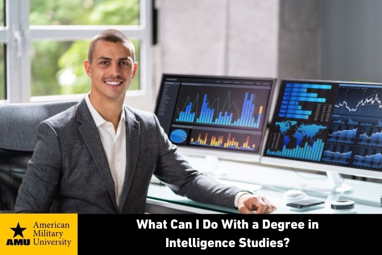 intelligence studies degree graduate sitting in front of large computer monitors